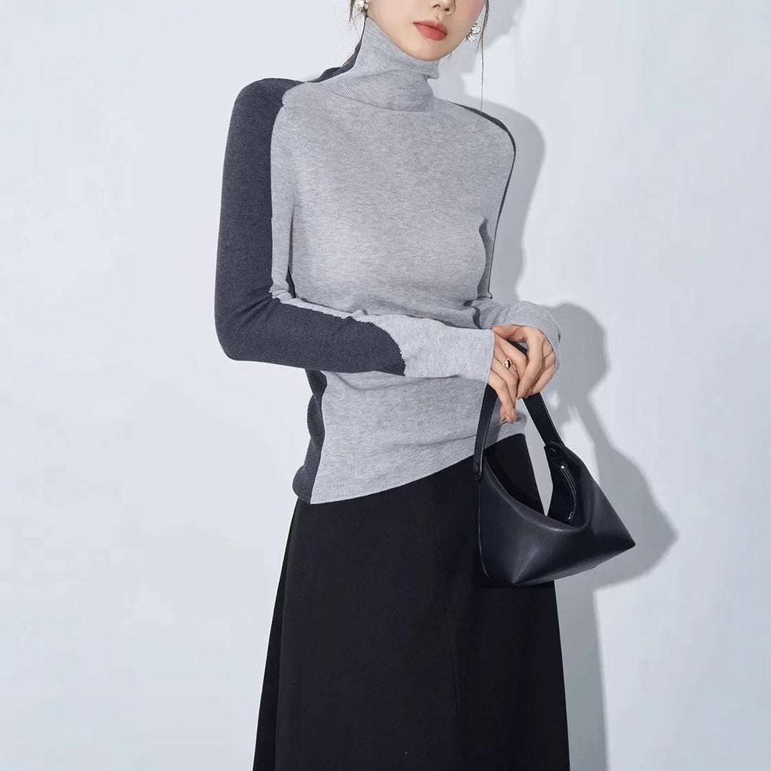 Women's sleek mock neck top featuring a sophisticated contrast sleeve design, perfect for elegant winter outfits.