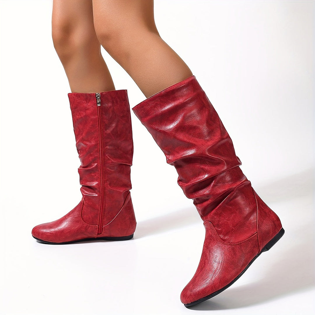 Black gathered flat knee-high boots for women, a stylish and comfortable choice for fall and winter fashion.