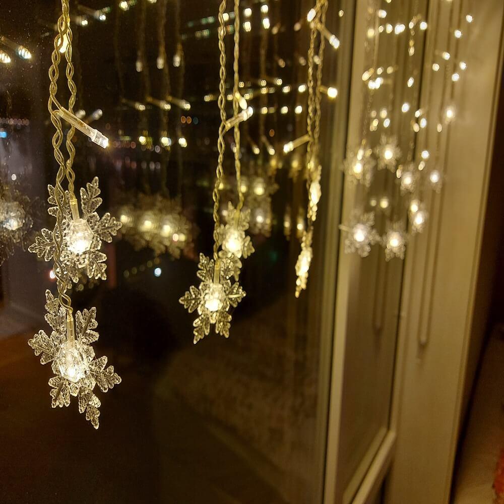 Indoor LED snowflake string lights adding a cozy, festive touch to any room's decor.