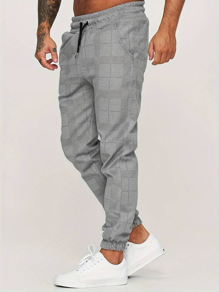 Comfortable men's modern checked jogger pants with a relaxed fit, great for travel and daily wear.