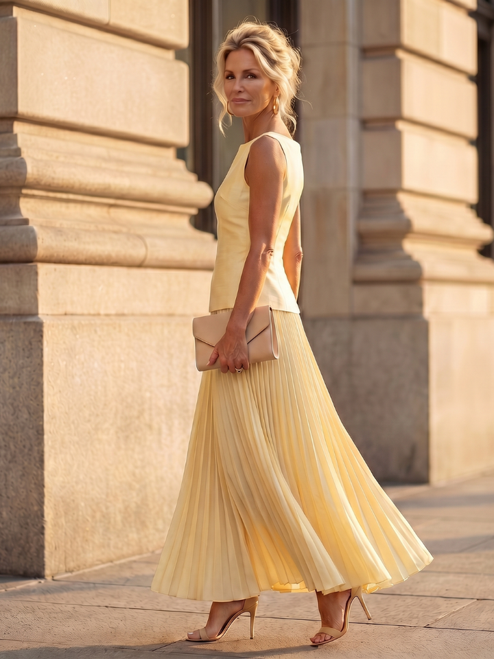 Chic women's two-piece, structured bodice & pleated maxi skirt, ideal for evening wear & special occasions.
