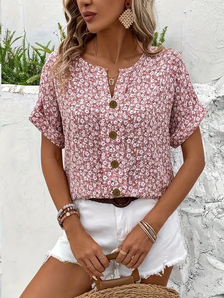 Elegant women's blouse with a beautiful floral print & functional button detail, a must-have feminine top.