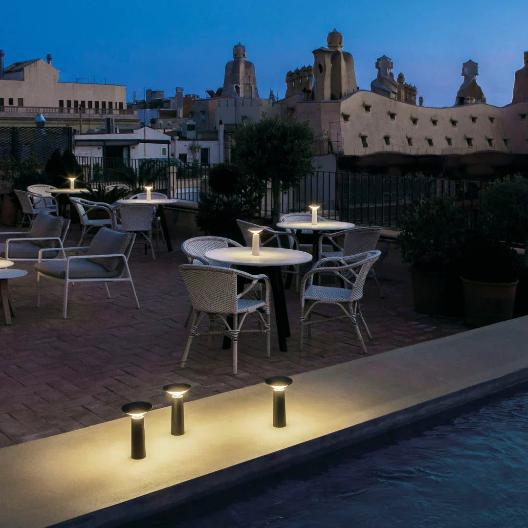 Modern minimalist LED lamp, dimmable, flexible, rechargeable for on-the-go lighting.