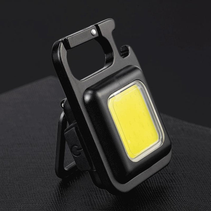 Rechargeable mini COB LED keychain flashlight. Portable everyday carry utility light.