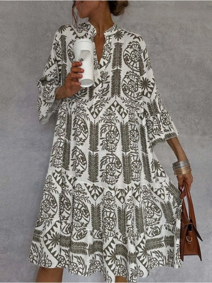 Detailed view of women's vibrant floral print on a relaxed fit midi tunic dress, showcasing spring/summer style.