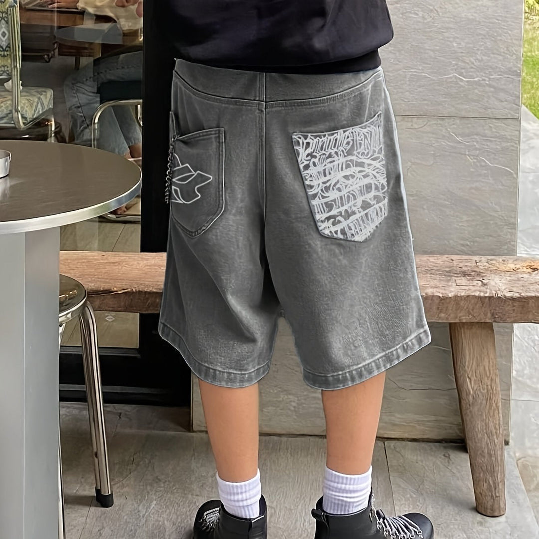 Men's fashion denim shorts with tasteful floral embroidery, offering a modern casual vibe.