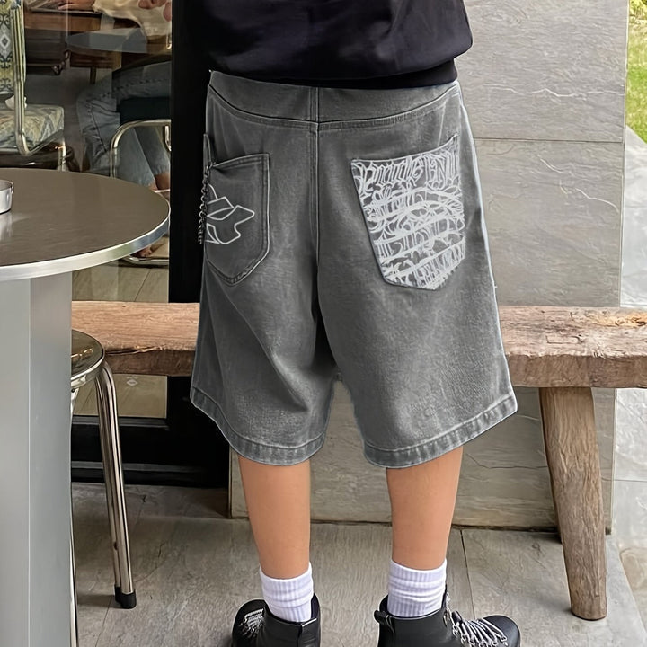 Men's fashion denim shorts with tasteful floral embroidery, offering a modern casual vibe.
