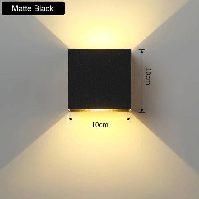 Contemporary LED wall sconce, up/down lighting. Aluminum cube design brightens modern home interiors.