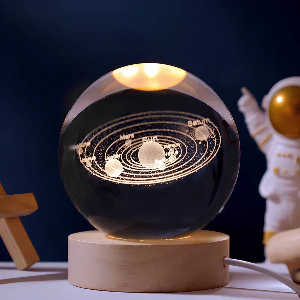 Detailed 3D engraved universe in a crystal ball LED lamp with a warm wooden base. Great desktop lamp.
