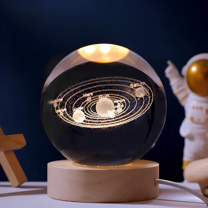 Detailed 3D engraved universe in a crystal ball LED lamp with a warm wooden base. Great desktop lamp.