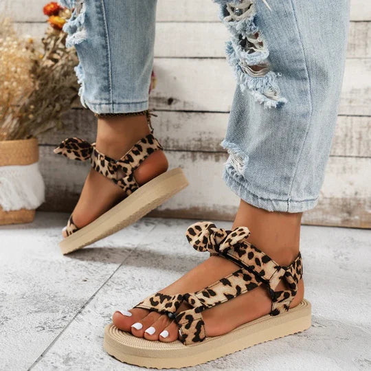 Women's leopard print slip-on sandals, stylish & comfortable flat summer shoes for a bold fashion statement.