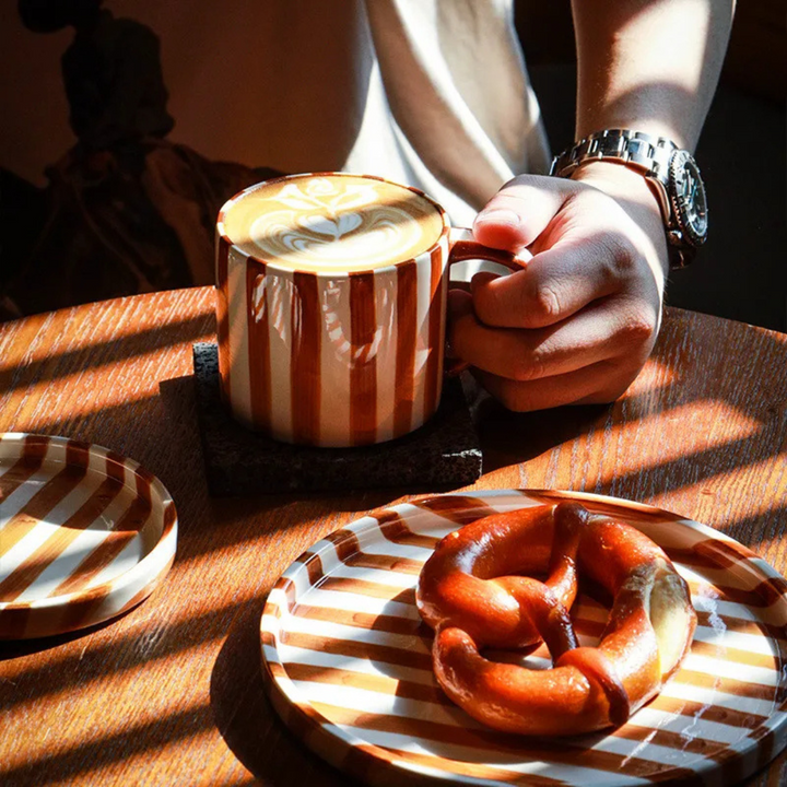 Beautiful hand-painted ceramic cup and saucer set with a vintage design, ideal for coffee or tea.
