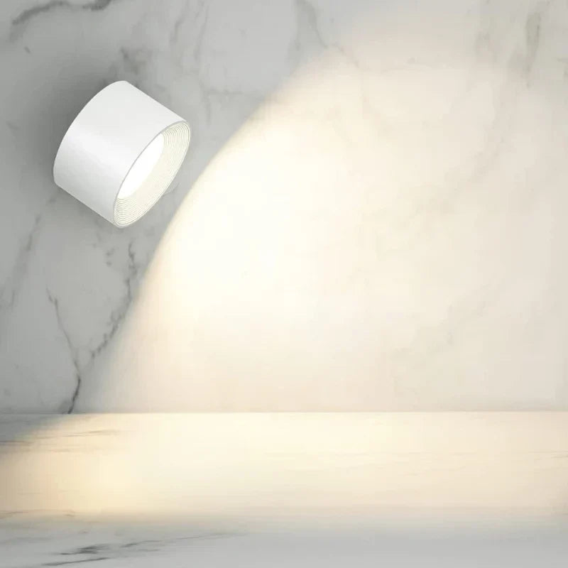 Modern cordless wall lamp, dimmable LED, rotatable for directed task or ambient lighting.