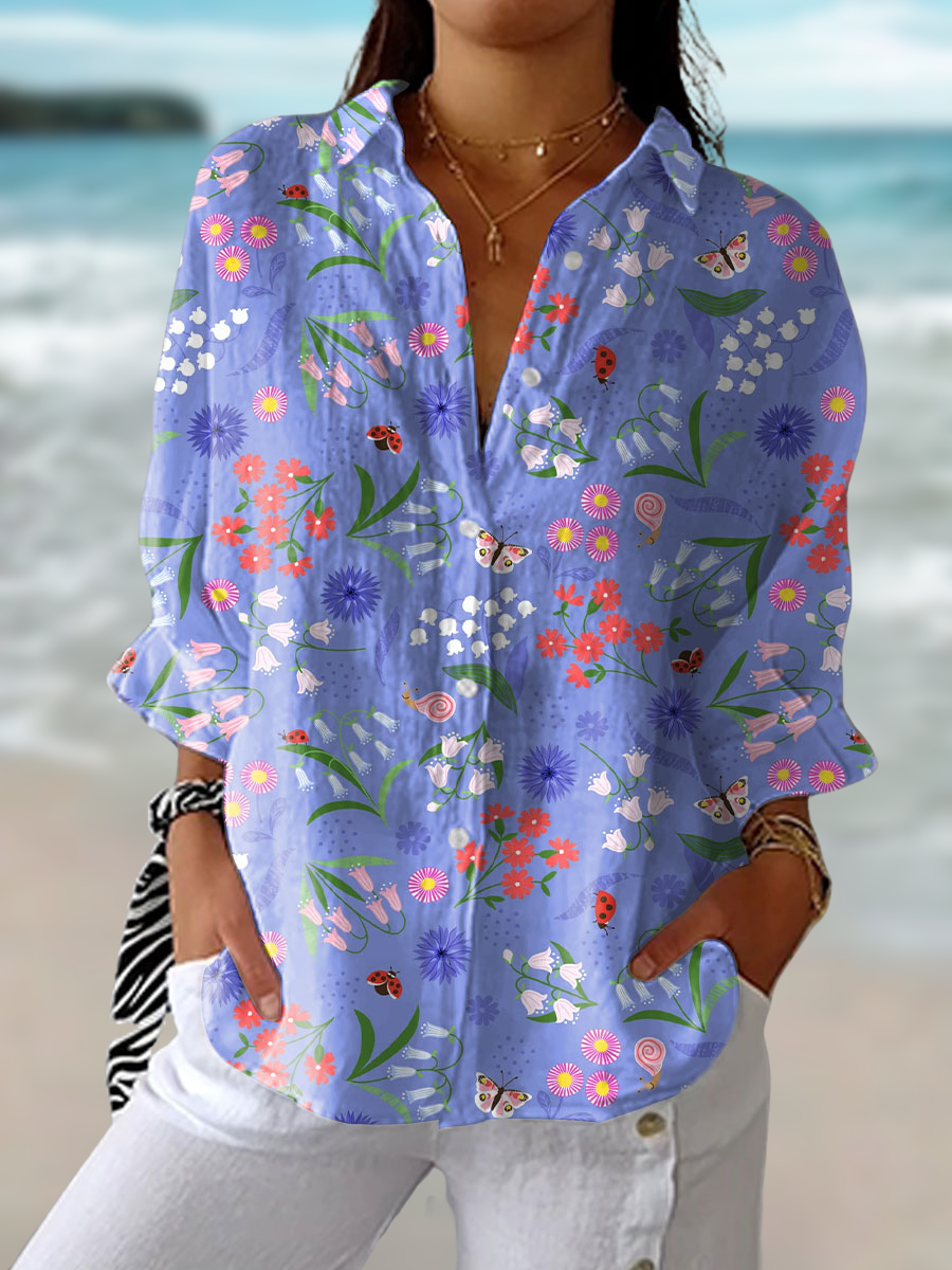 Women's Bloom Meadow floral short-sleeve purple blouse. Elegant spring/summer top with a versatile casual chic style.