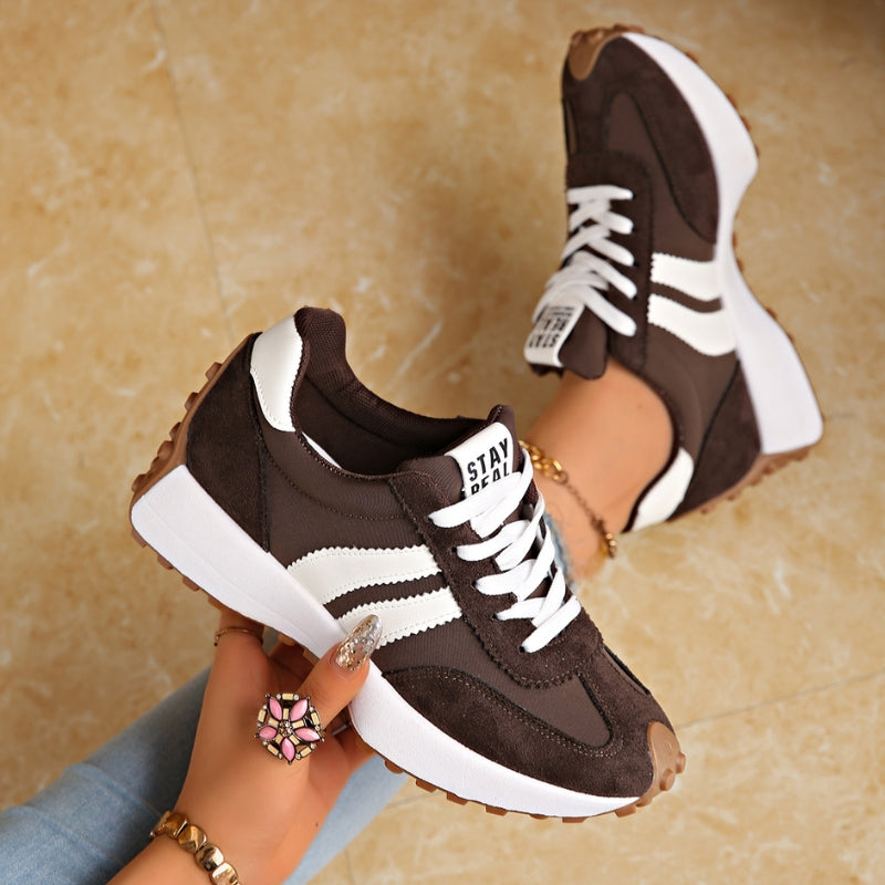 Fashionable women's retro platform sneakers with chunky sole, lace-up, stripe detail, vintage casual look.
