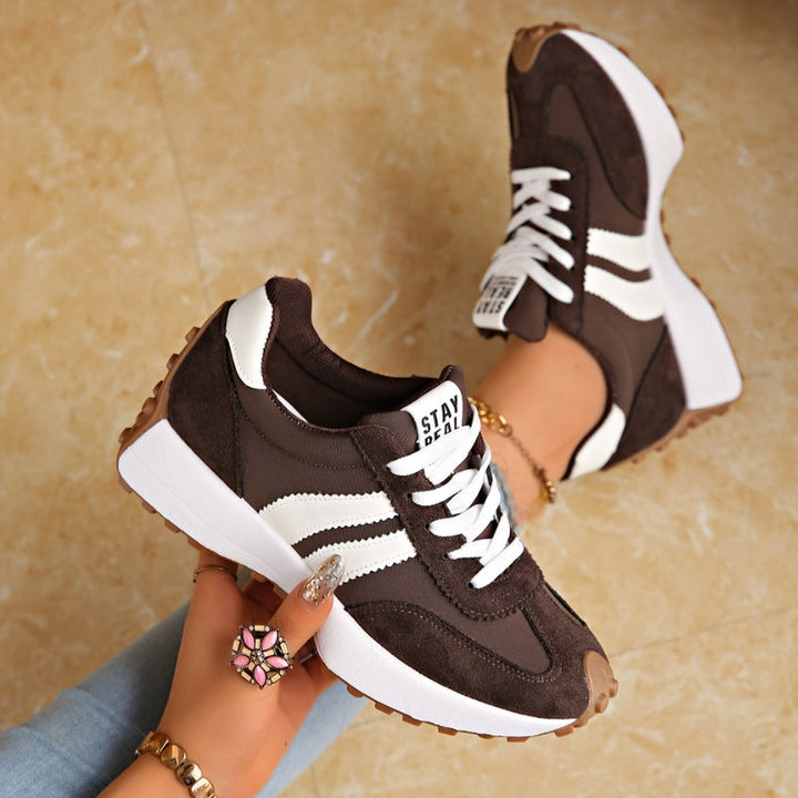 Fashionable women's retro platform sneakers with chunky sole, lace-up, stripe detail, vintage casual look.