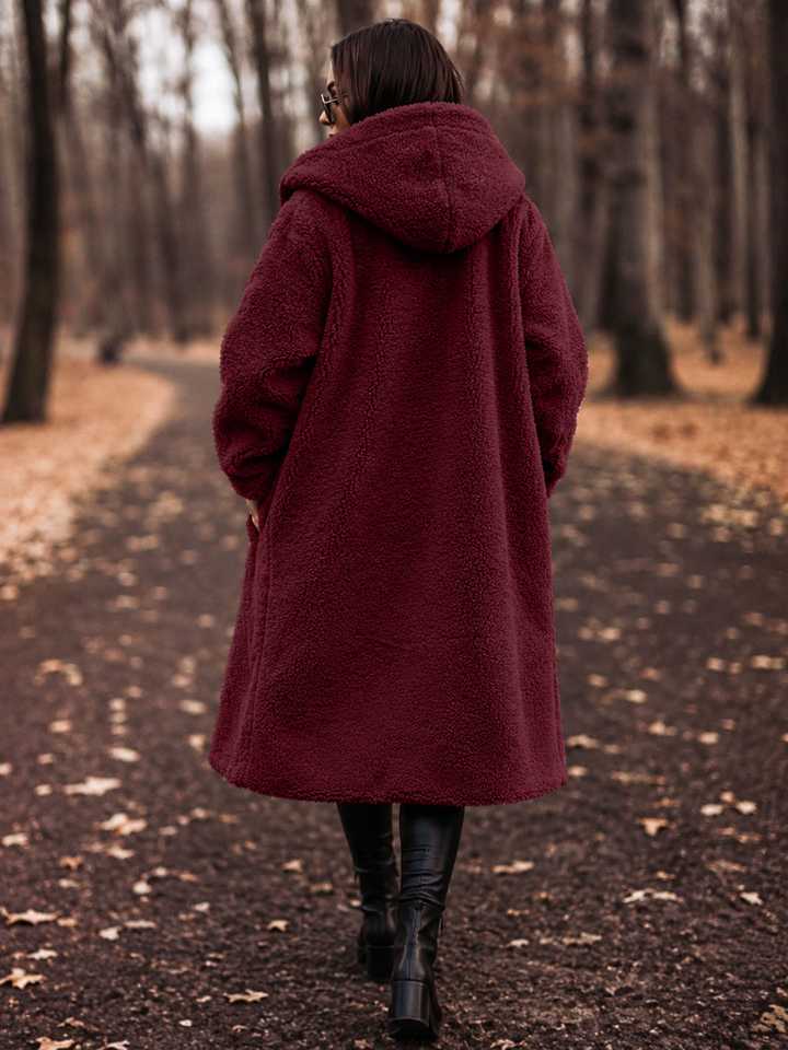 Cozy hooded women's winter coat, elegant outerwear for versatile seasonal styling.