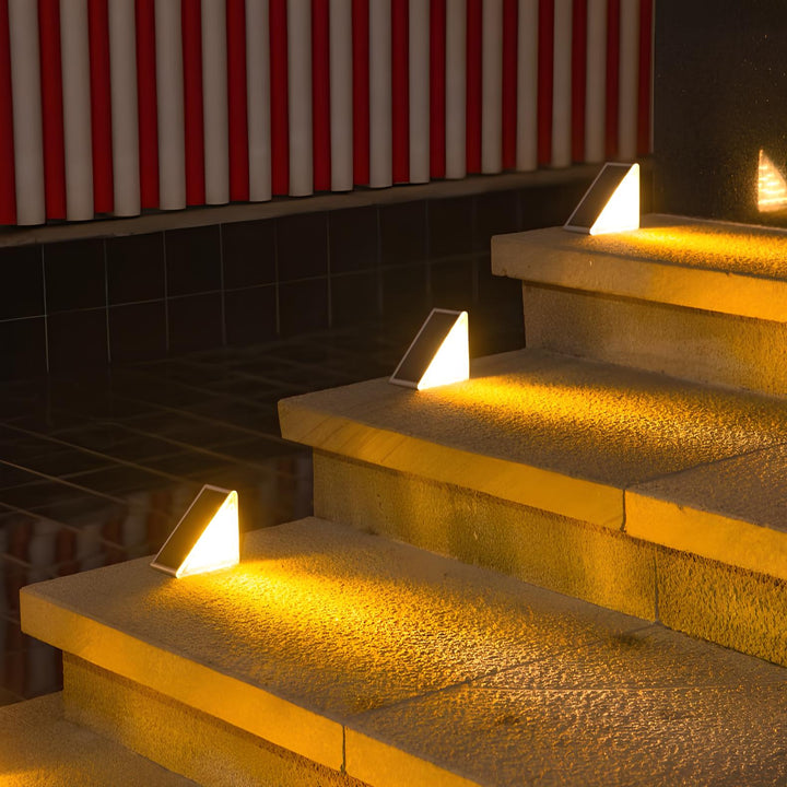 Solar pathway lights lining a garden walkway, offering safe exterior lighting and decorative accent at night.