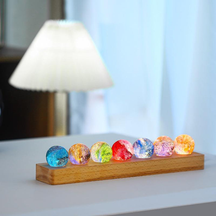 Nvroome Lights decorative orb with galaxy crystal design and warm wooden LED base.