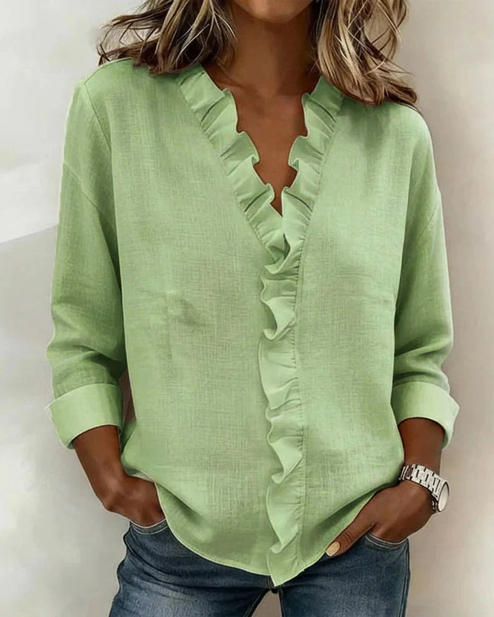 Versatile women's V-neck blouse with delicate ruffles, long sleeves, suitable for everyday or dressier looks.