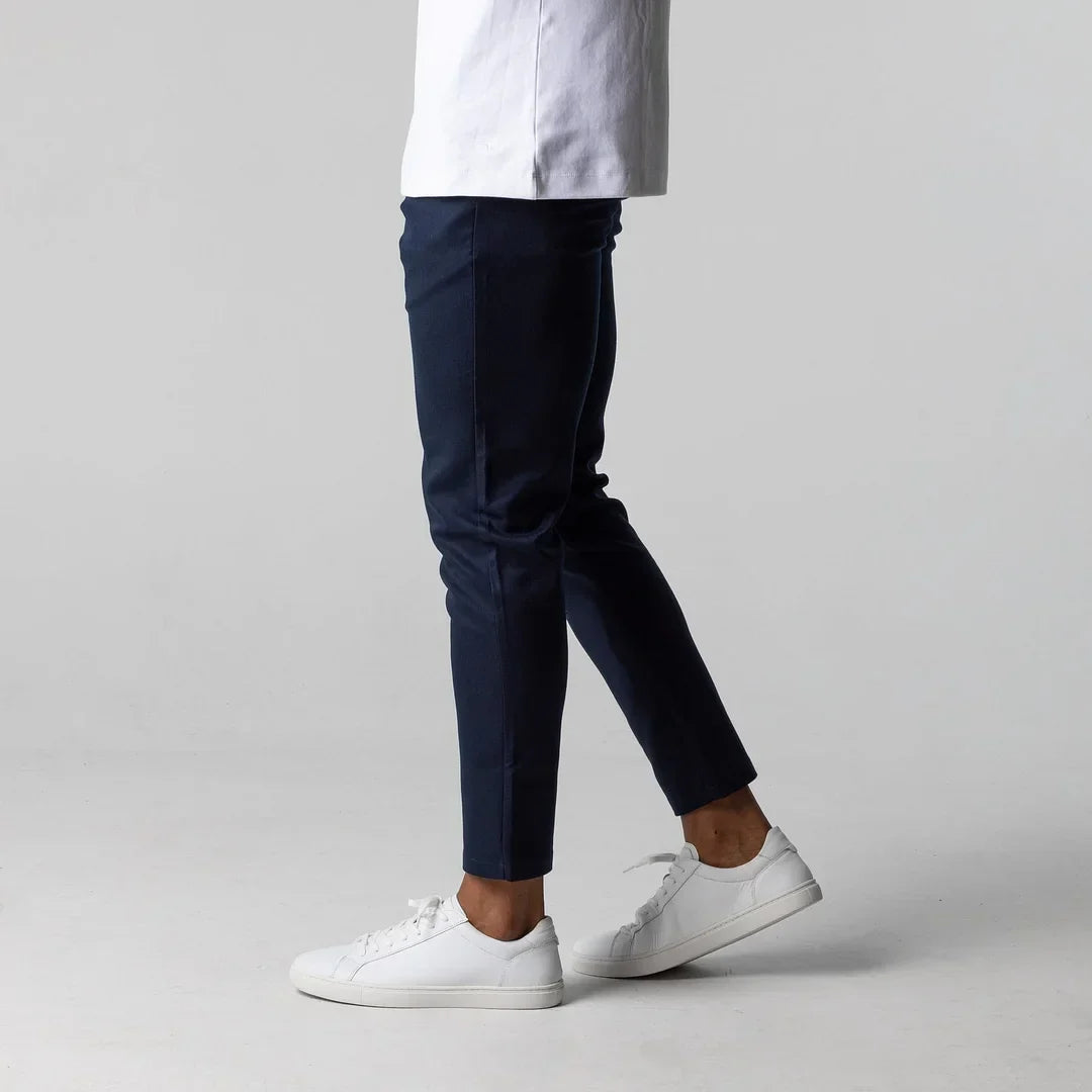 Man in grey active chinos, illustrating freedom of movement & stylish comfort.