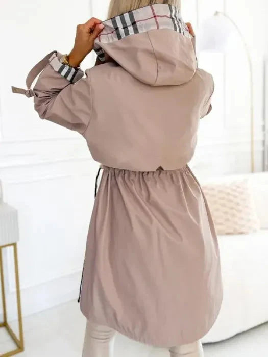 Functional & stylish women's hooded rain jacket; all-weather waterproof outerwear for everyday versatility.