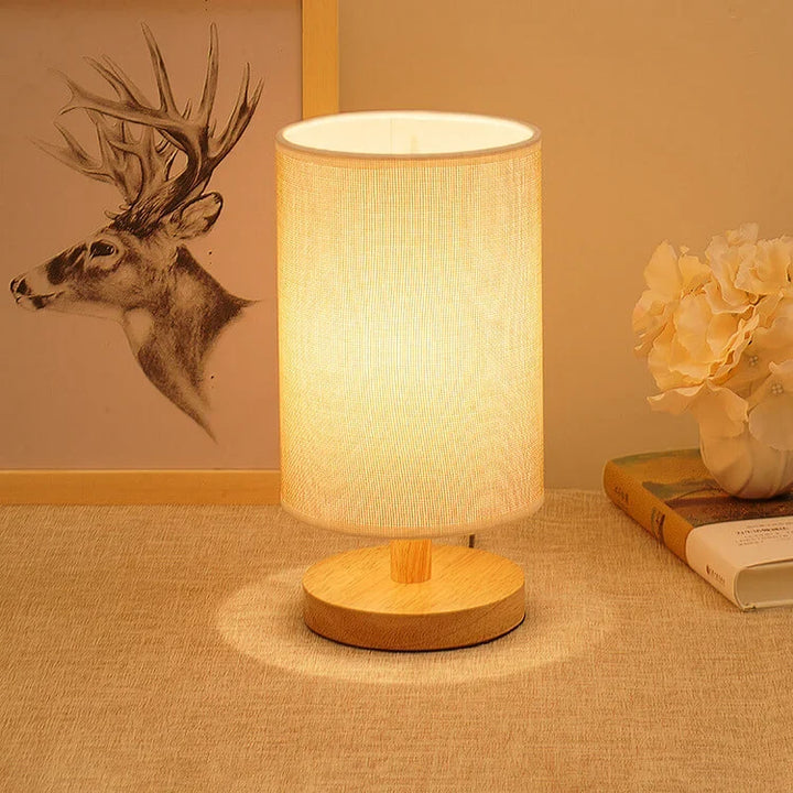 Modern wood base table lamp. Fabric shade, dimmable LED light. Perfect accent for natural home decor.