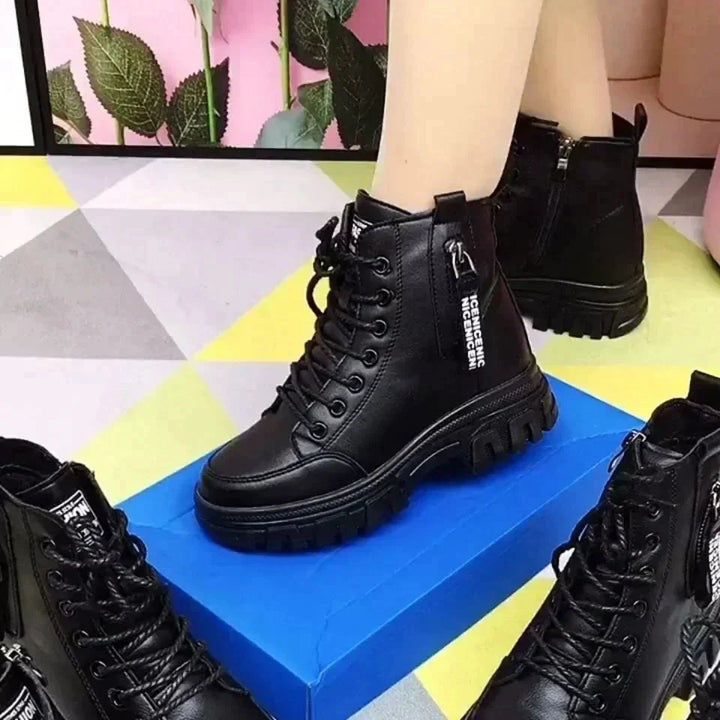 Durable women's combat boots, high-top leather design with comfortable fit, side zipper, and classic laces.