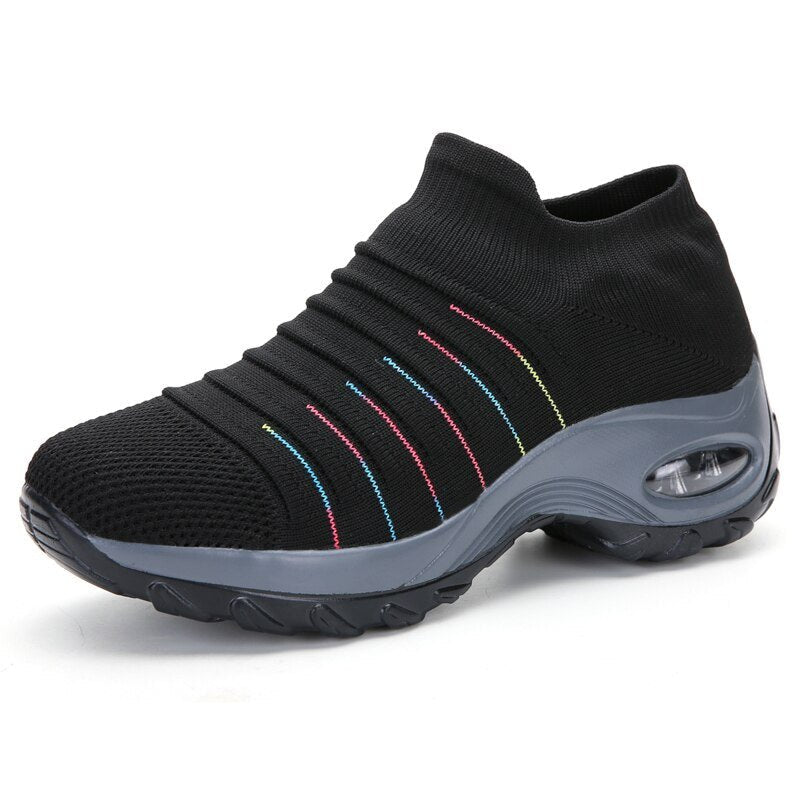 Side view of women's orthopedic slip-on sneakers, showing breathable mesh and memory foam.