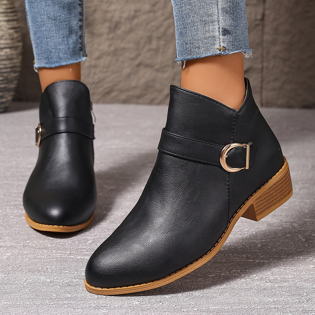 Modern women's Chelsea ankle boots, black, with unique buckle detail, perfect for fashion and comfort.