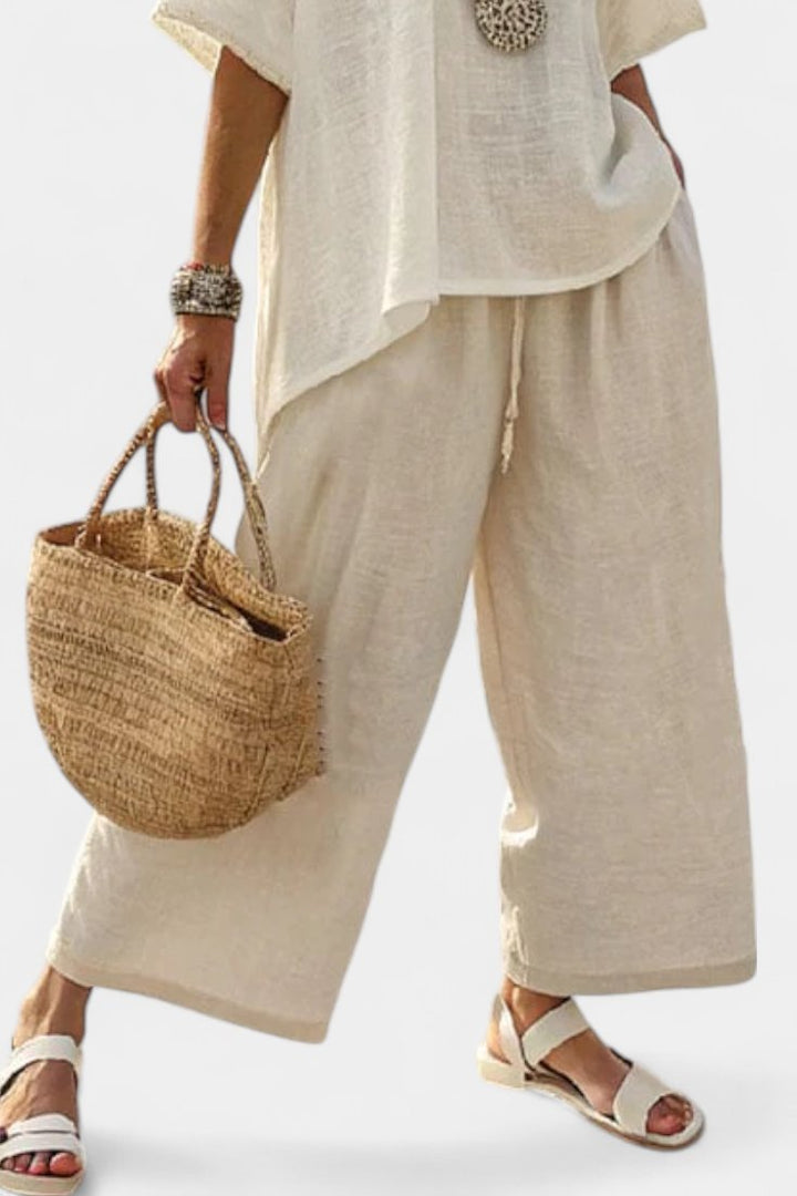 Stylish women's asymmetrical top & wide-leg trousers two-piece set, ideal for travel wear & casual elegance.
