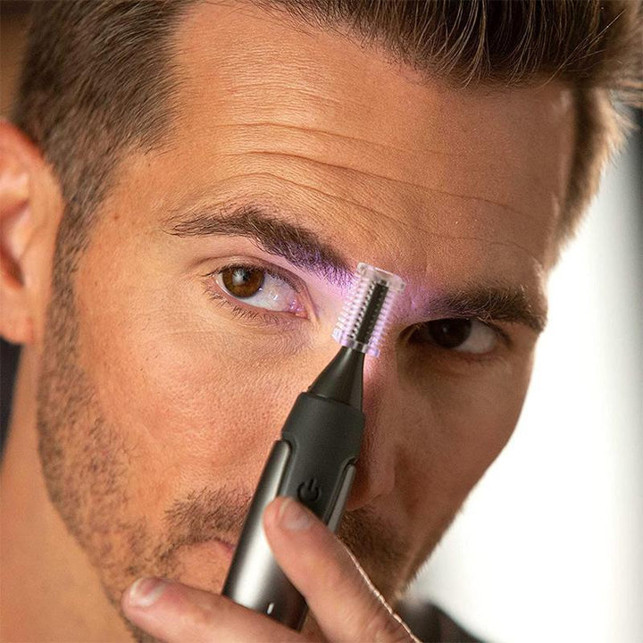 Man using a Precision Trimmer with LED light to perfectly shape his beard and facial hair.