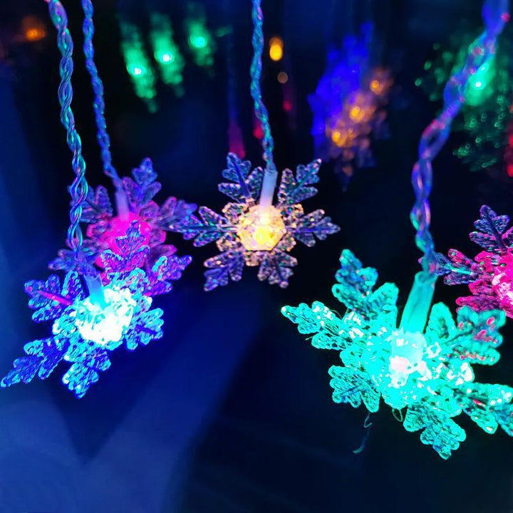 Durable outdoor & indoor LED snowflake string lights for year-round festive illumination.