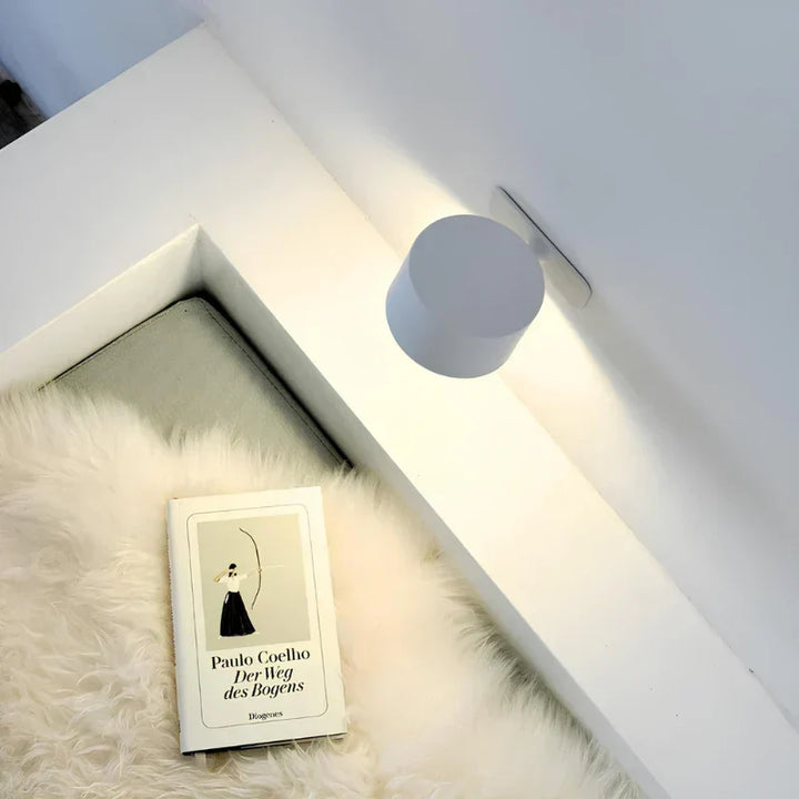 Sleek universal LED wall light, rechargeable, dimmable, 360-degree rotating head.