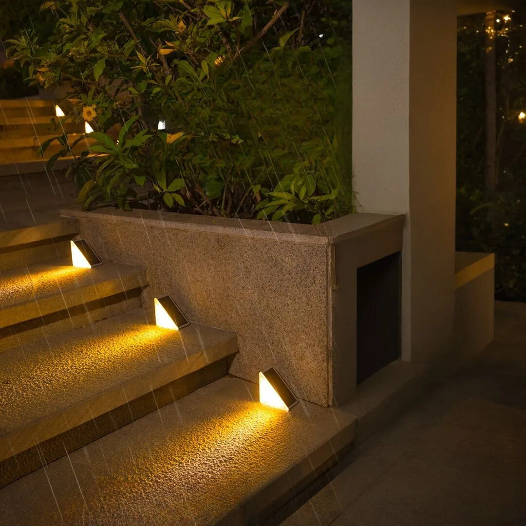 Sleek solar powered stair light with built-in panel, ready for charging and outdoor use in daylight.