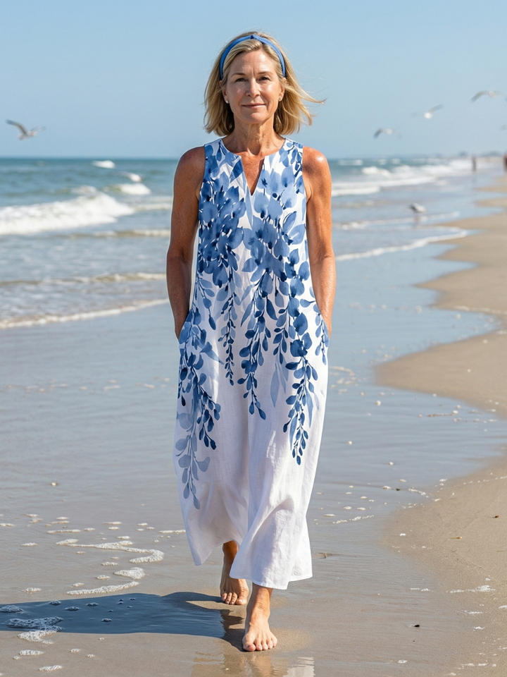 Women's sleeveless botanical print maxi dress with a flowy, relaxed fit, perfect for summer casual wear.