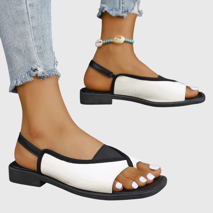 Trendy women's flat sandals with a modern square toe. Comfortable slip-on style for beach & casual outfits.