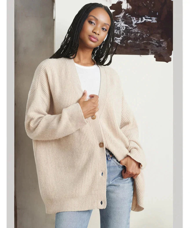 Modern women's knit vest in black, button-front design, offering versatility and warmth.