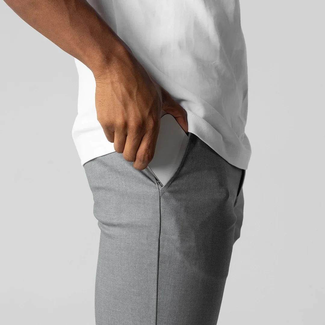 Close-up of fabric on grey active chino pants, highlighting stretch and texture.