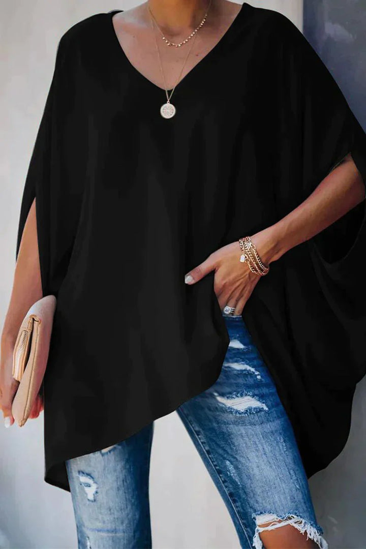 Relaxed fit women's V-neck tunic top featuring stylish batwing sleeves and an oversized, comfortable design.
