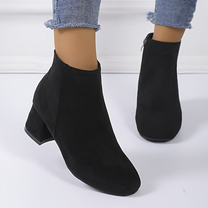 Elegant black women's Chelsea ankle boots with comfortable block heel. Ideal for stylish fall & winter outfits.