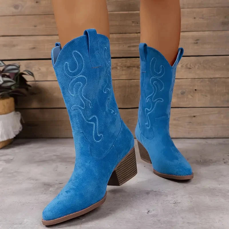 Detailed view of women's elegant ankle cowboy boots showcasing intricate western stitching and block heel.