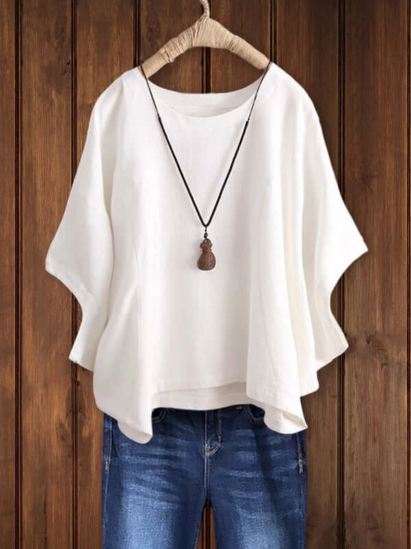 Stylish loose-fit dolman-sleeve tunic top for women, featuring a classic crew neck. Perfect for relaxed spring fashion.