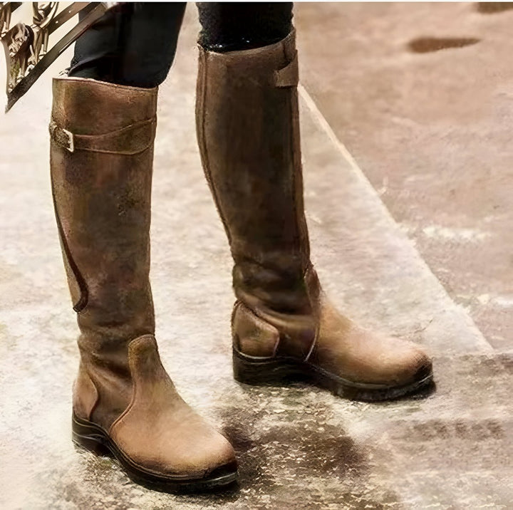Durable women's waterproof riding boots, knee-high with adjustable buckle for comfortable fit.