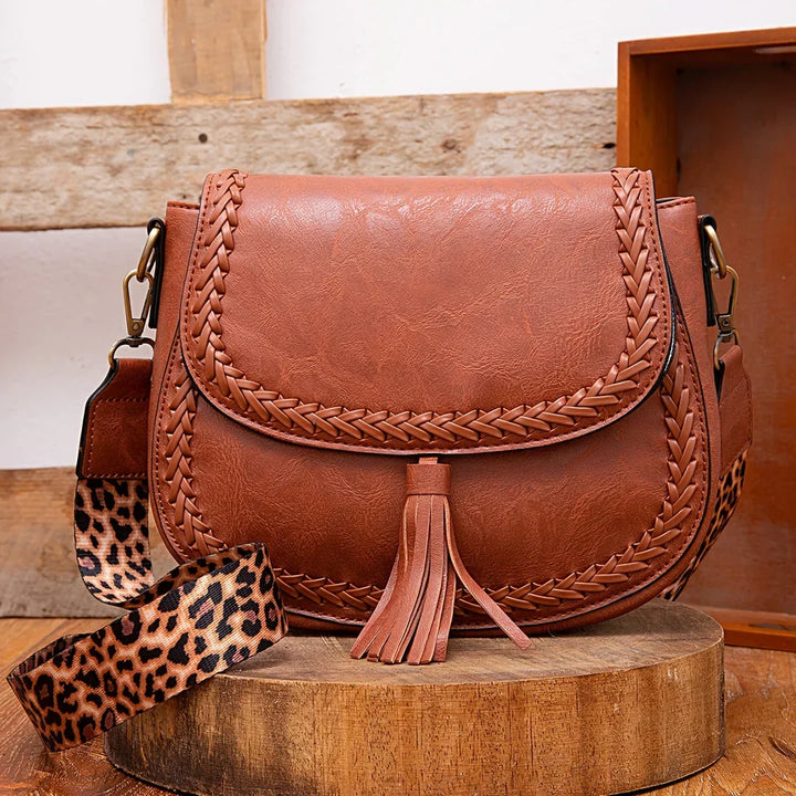 Chic women's faux leather shoulder bag with a stylish tassel, perfect for everyday wear.