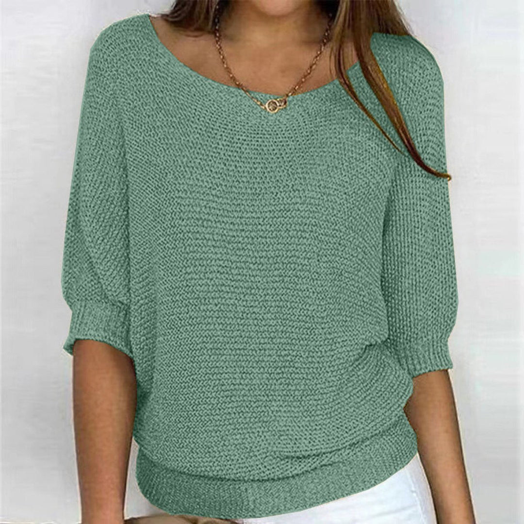 Relaxed fit women's knit sweater with elegant batwing sleeves, offering cozy comfort & chic style.