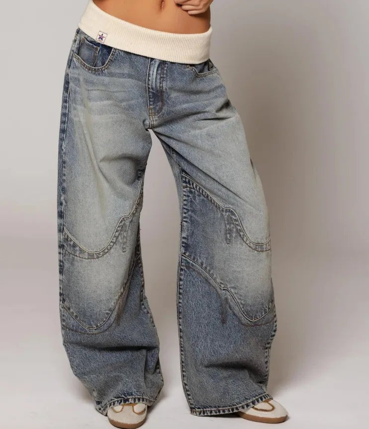 Women's vintage light wash wide leg jeans with unique patchwork design. Comfortable baggy fit for casual streetwear.