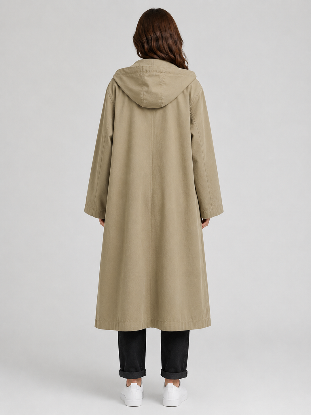 Detail of a women's classic long trench coat, showcasing the waterproof fabric and stylish lapels.