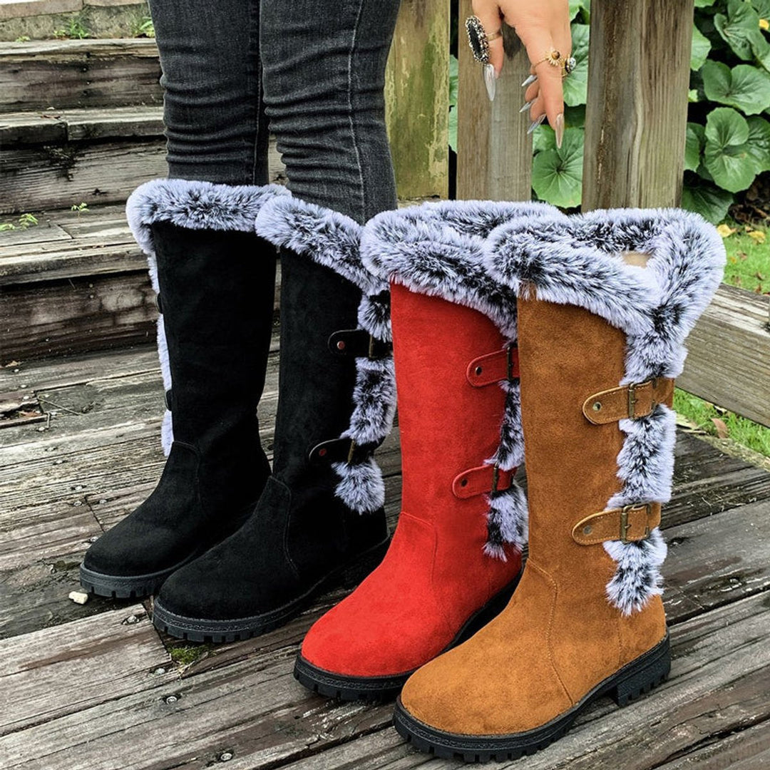 Red women's buckle knee-high boots with cozy fur trim, a bold fashion statement for winter.
