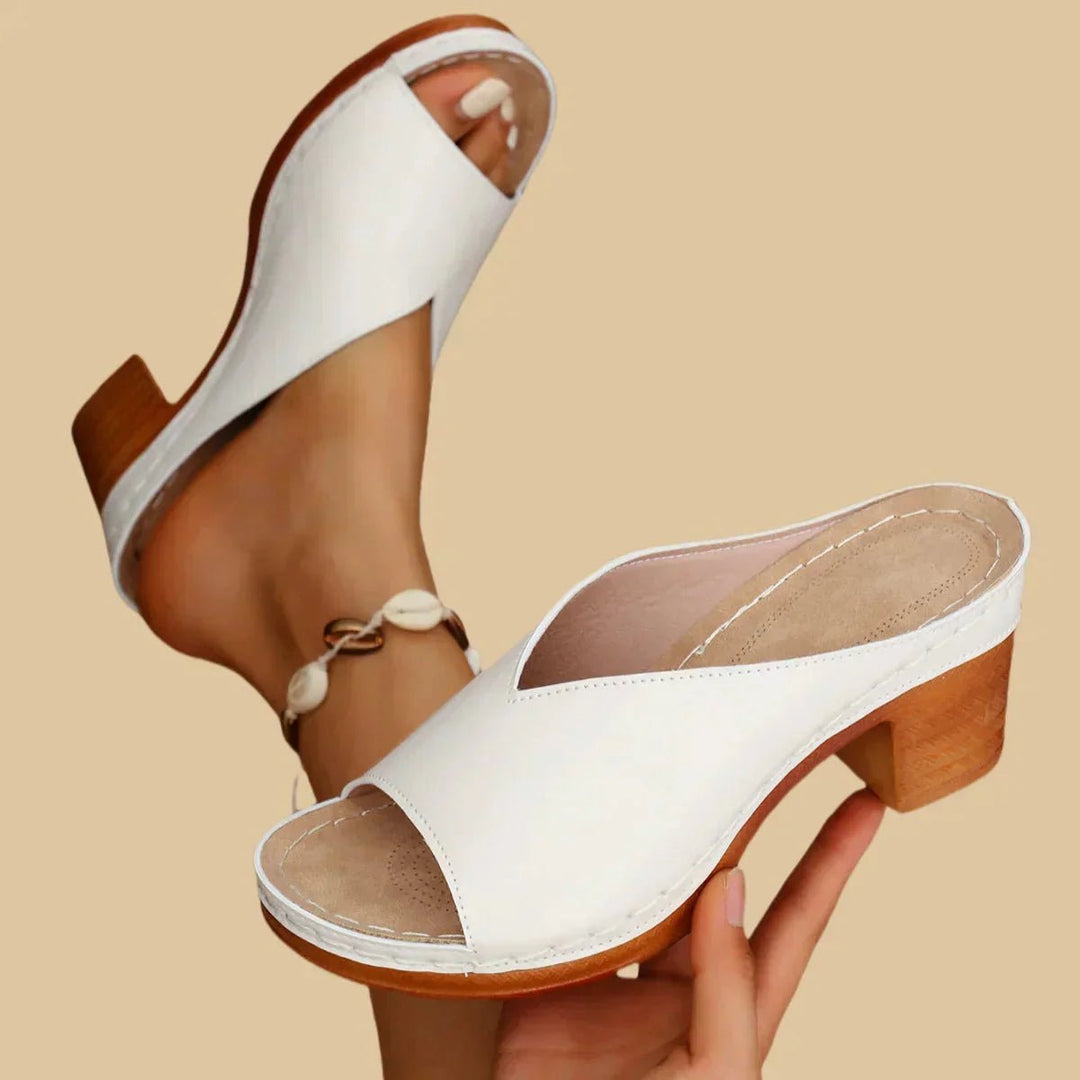 Comfortable women's open-toe sandals with a supportive block heel, perfect orthopedic footwear for summer fashion.